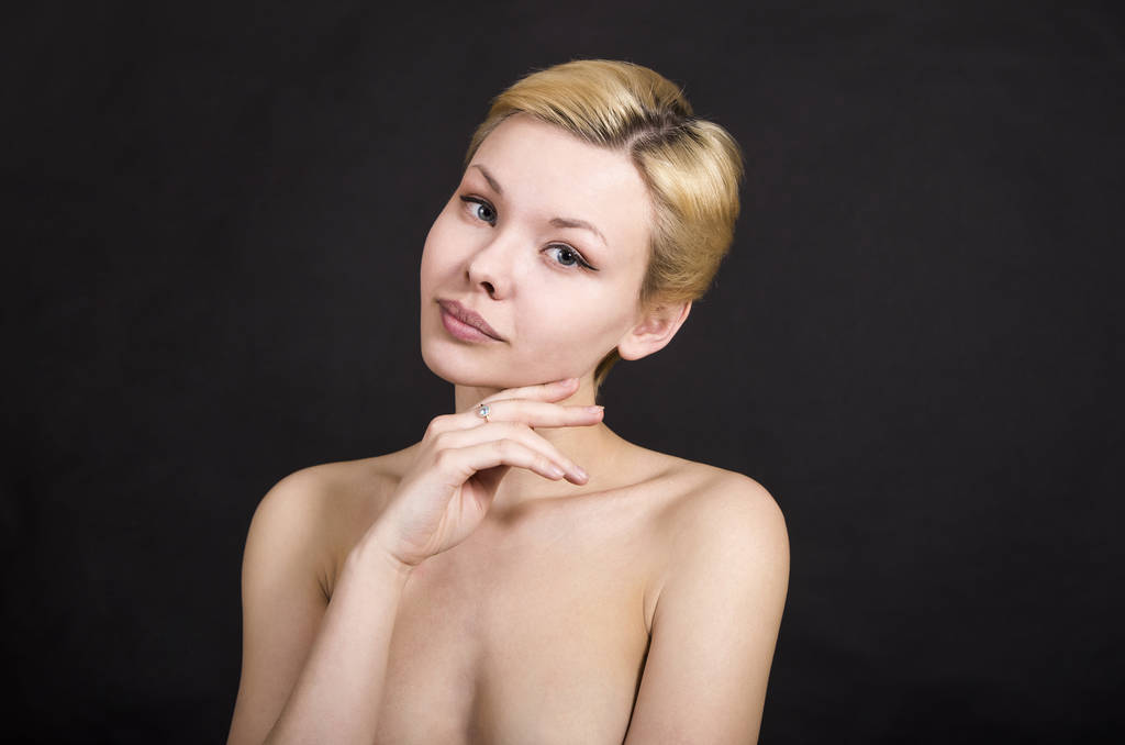 Portrait of blonde girl on dark background. - Photo, Image