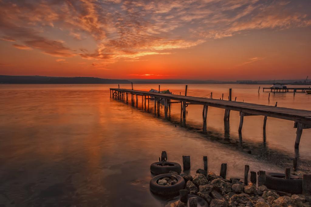Stunning sunset at the harbour with wooden pier - Photo, Image