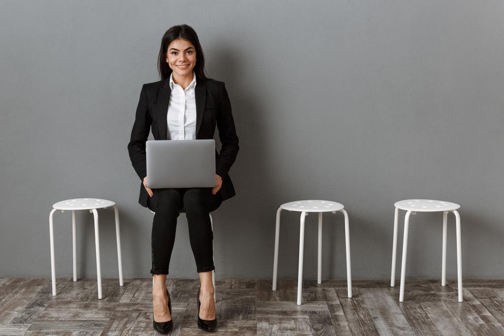 smiling businesswoman in suit with laptop waiting for job interview - Photo, Image
