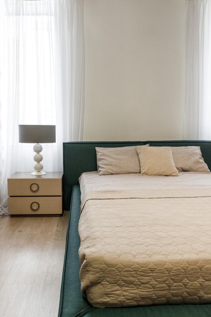 Світла постільна білизна на ліжку в затишній спальні
 - Фото, зображення