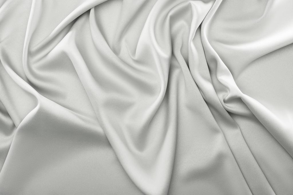 close up view of folded grey silk fabric as backdrop - Photo, Image