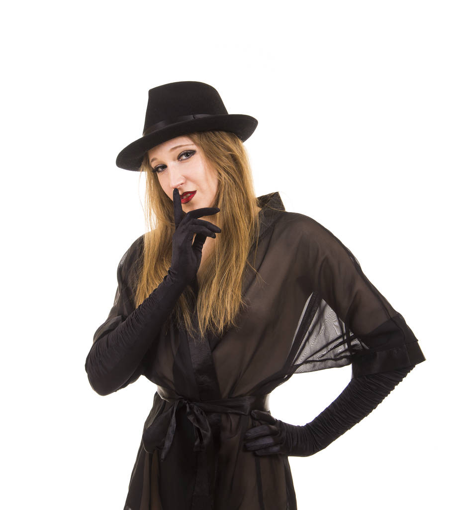 Menina bonita em túnica preta, chapéu preto e luvas pretas
. - Foto, Imagem