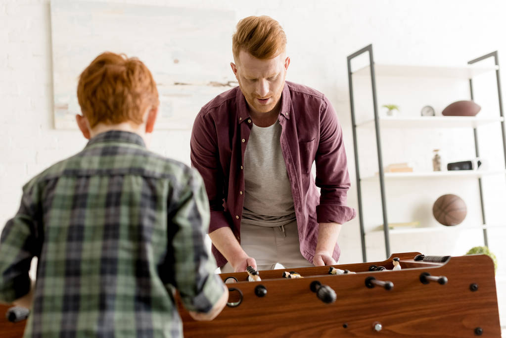 redhead father and son playing table football together at home   - Photo, Image