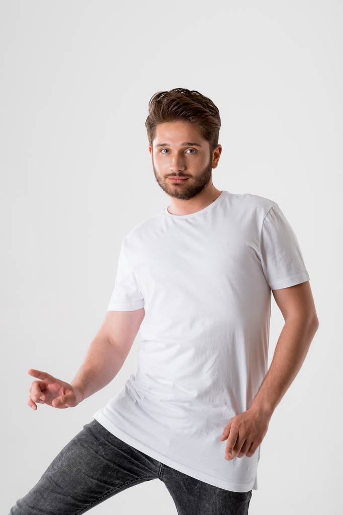 portrait of handsome bearded man in white shirt on grey background  - Photo, Image