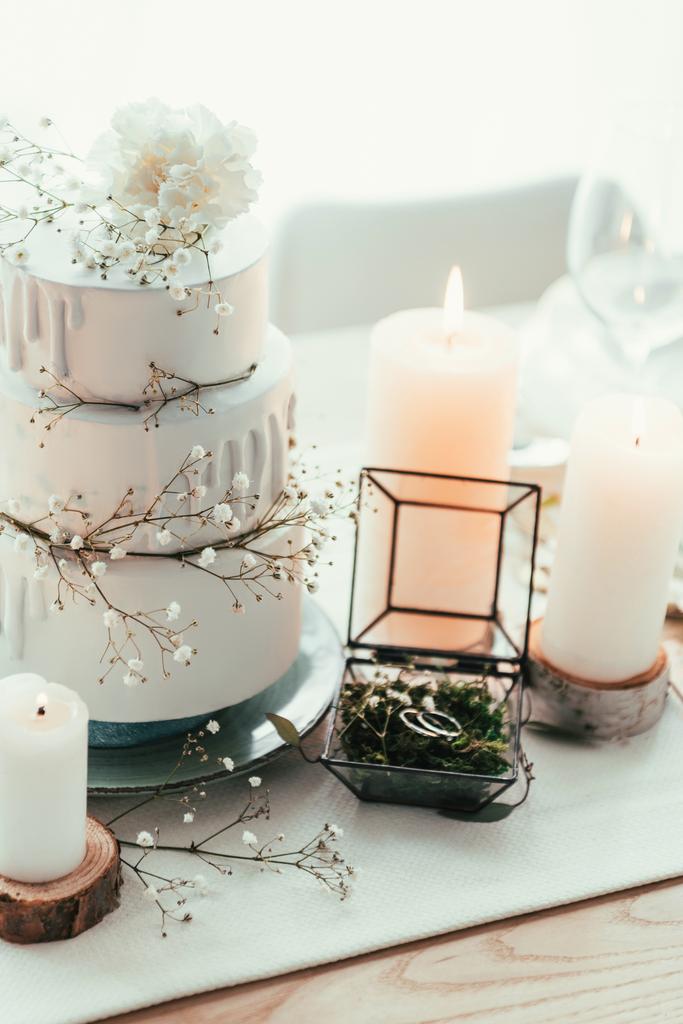 close up view of stylish table setting with candles and wedding rings for rustic wedding - Photo, Image