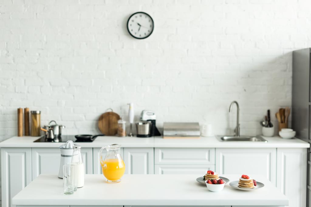 interior of kitchen with yummy pancakes and orange juice on kitchen counter - Photo, Image