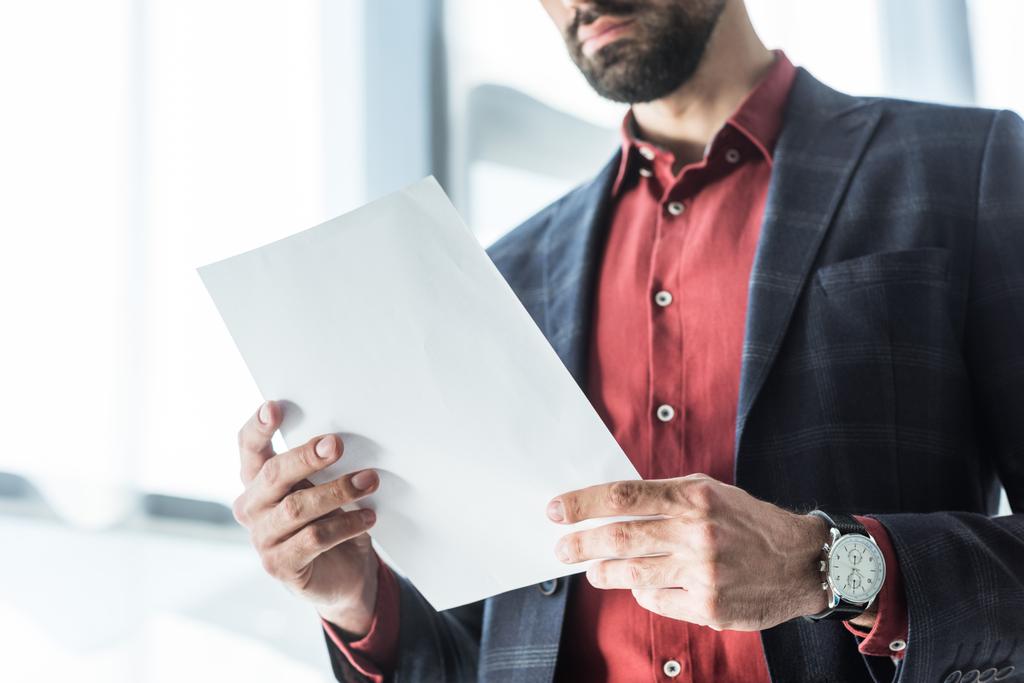 cropped shot of young businessman reading business document - Photo, Image