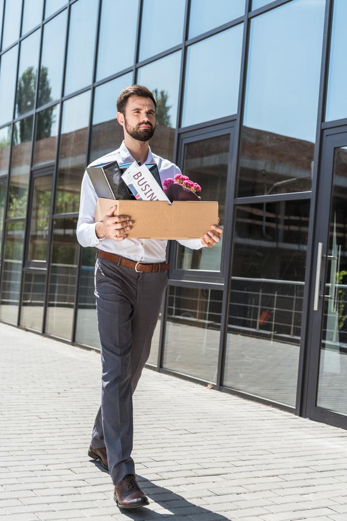 young manager with box of personal stuff outdoors after he was fired - Photo, Image