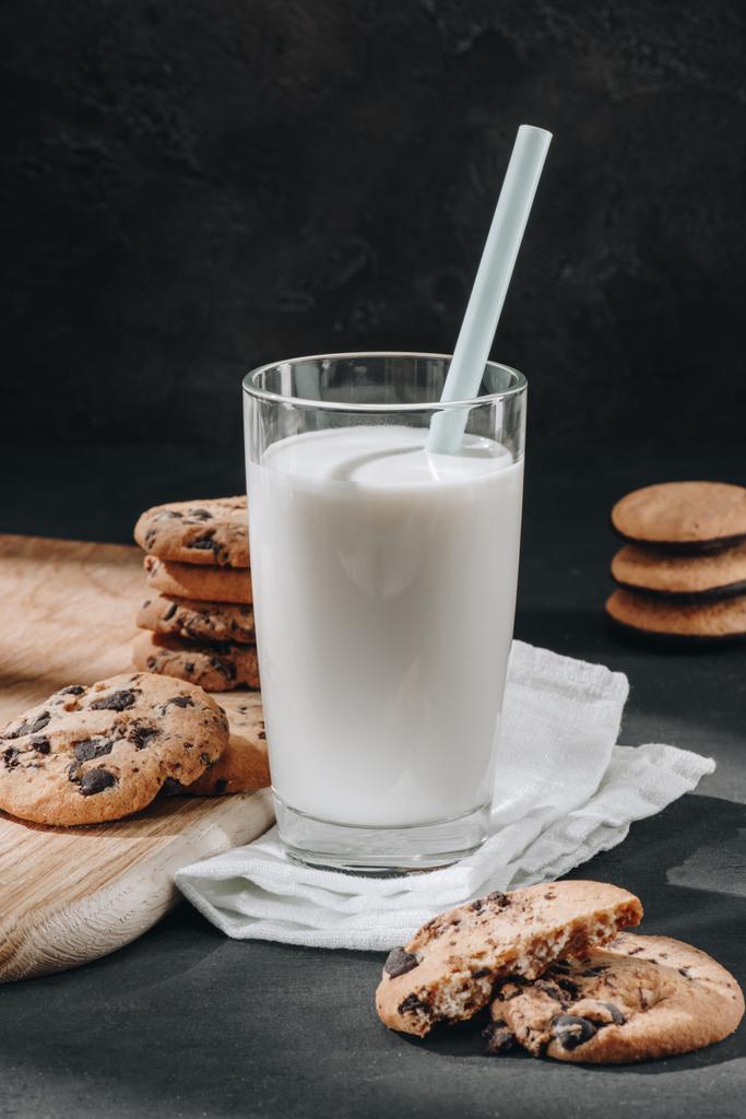 close-up shot of glass of milk with delicious chocolate-chip cookies - Photo, Image