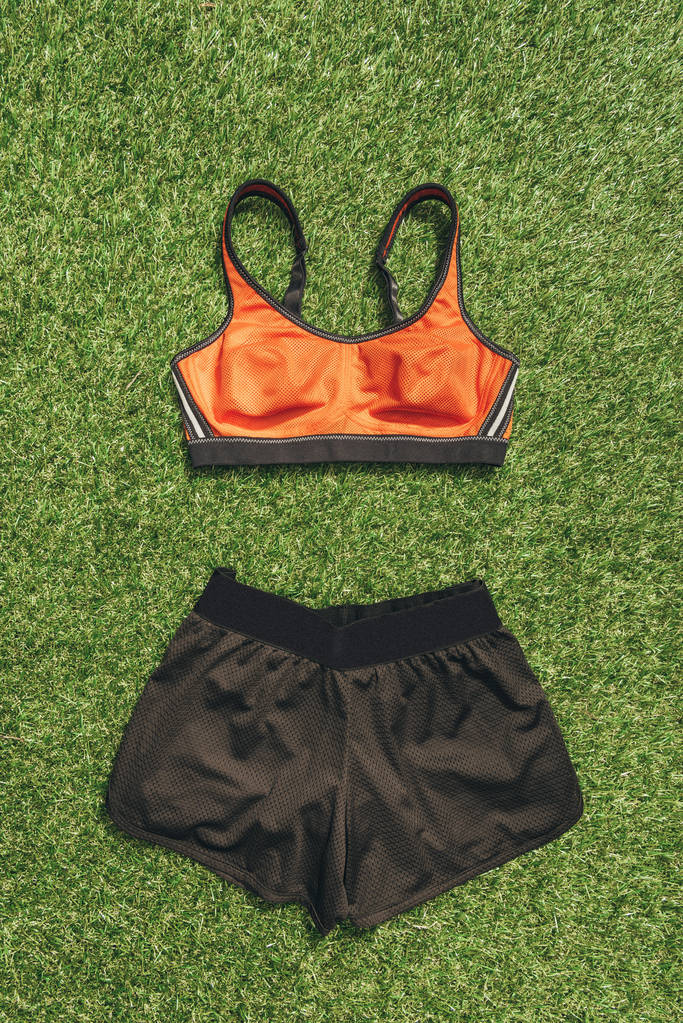 top view of feminine sportswear on green grass - Photo, Image