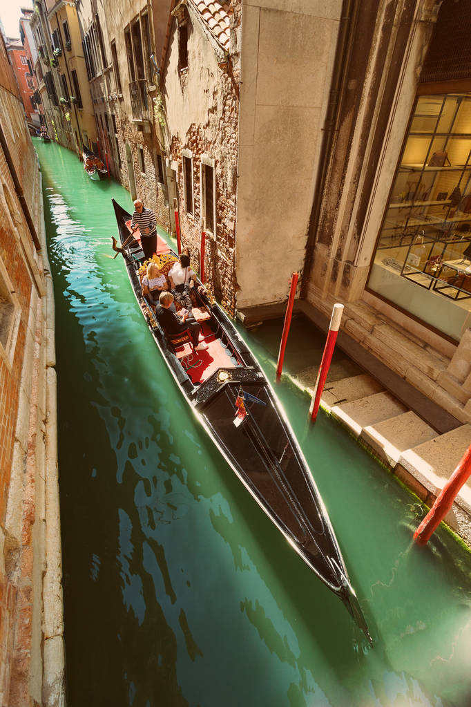 VENICE, VENETO, ITALY - Tourists, gondola riding, typical canal in Venice, September 21, 2017 - Photo, Image