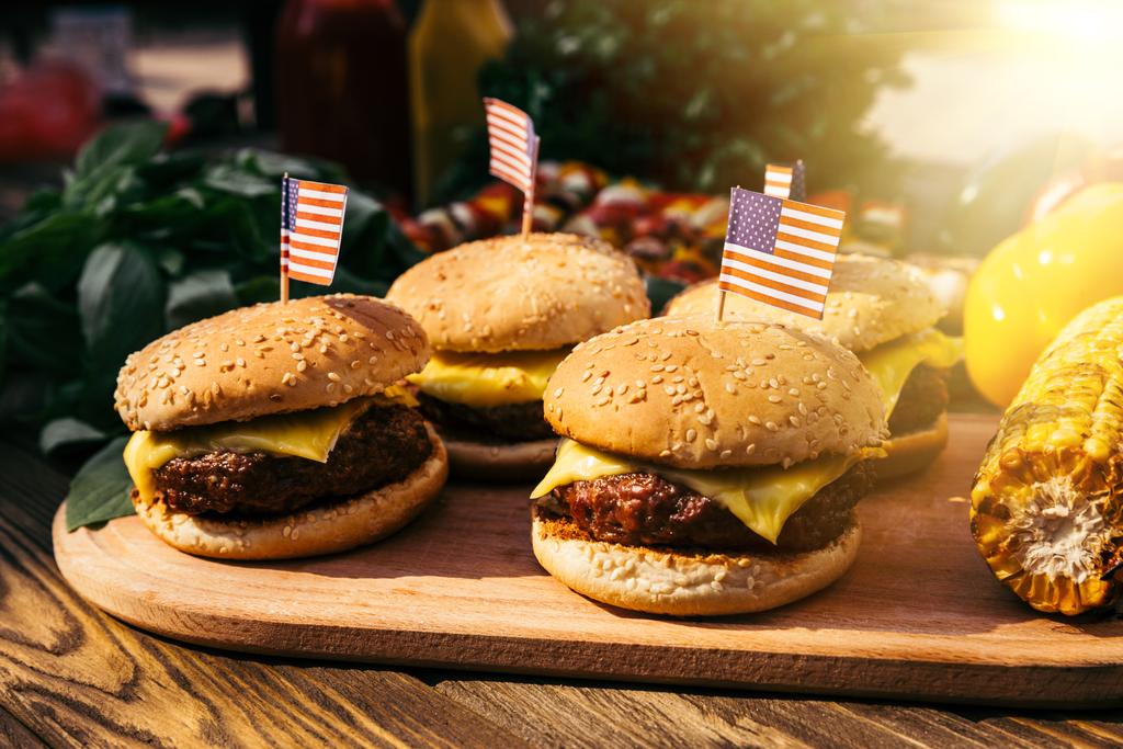 Burgers with us flags grilled for outdoors barbecue - Photo, Image