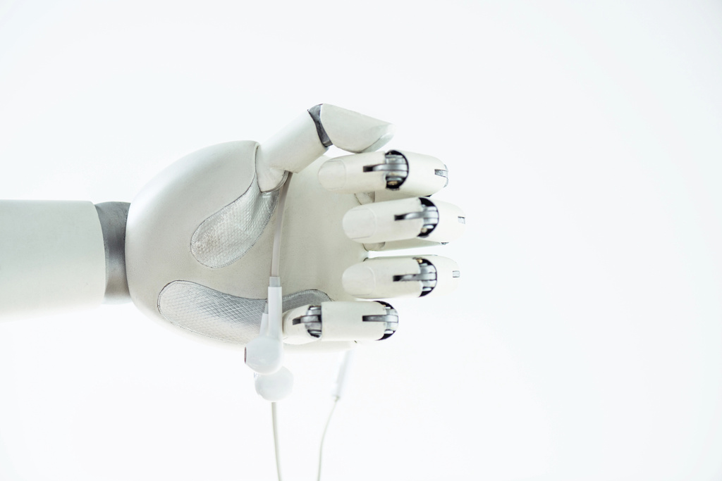 close-up view of robotic hand holding earphones isolated on white - Photo, Image