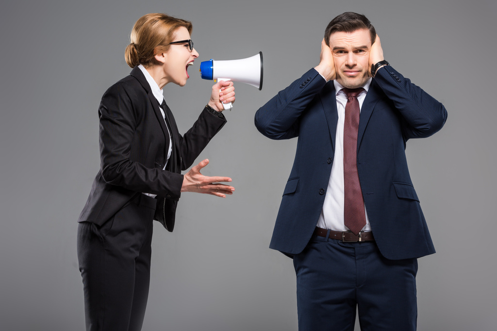 angry businesswoman with bullhorn screaming at businessman, isolated on grey, feminism concept - Photo, Image