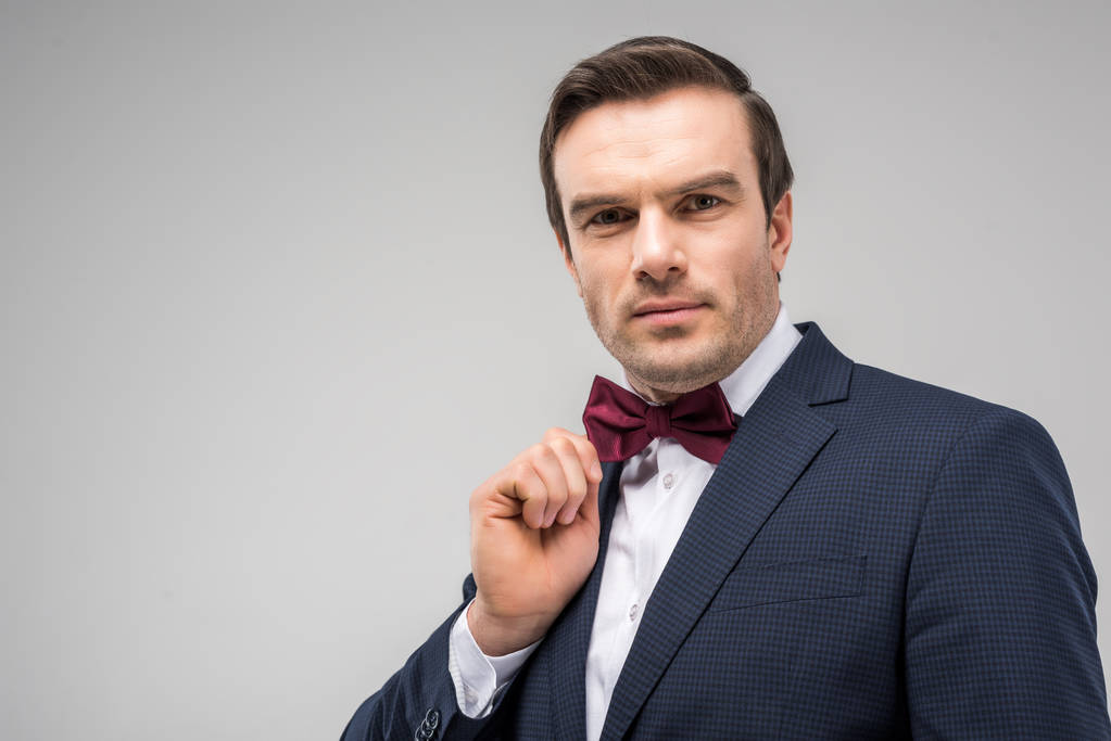 portrait of handsome man posing in festive bow tie, isolated on grey - Photo, Image