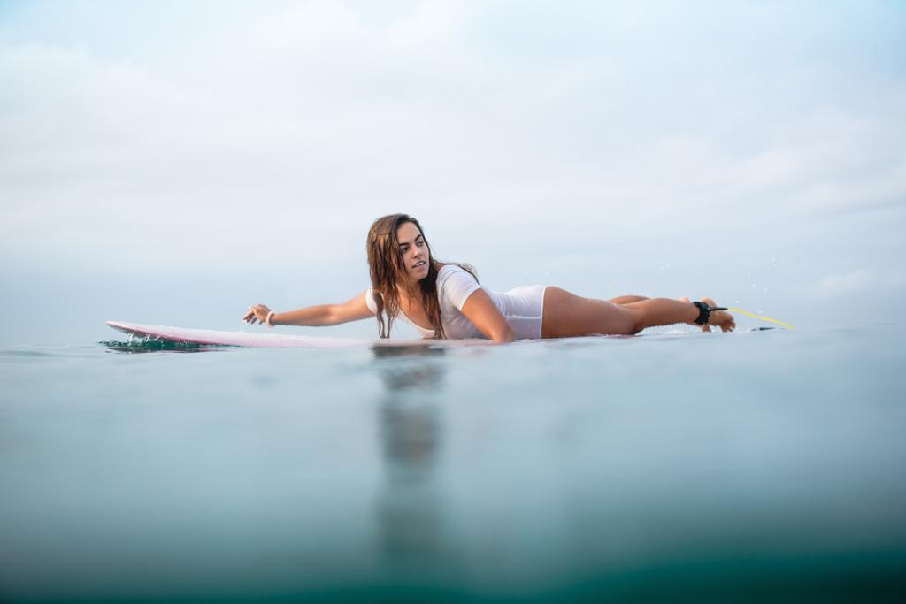 krásná mladá žena, plavání na surfovací prkno v oceánu - Fotografie, Obrázek