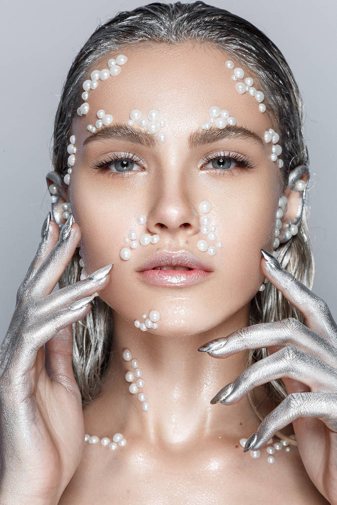 High-fashion portrait of young woman with pearls on face and silver hair - Photo, Image