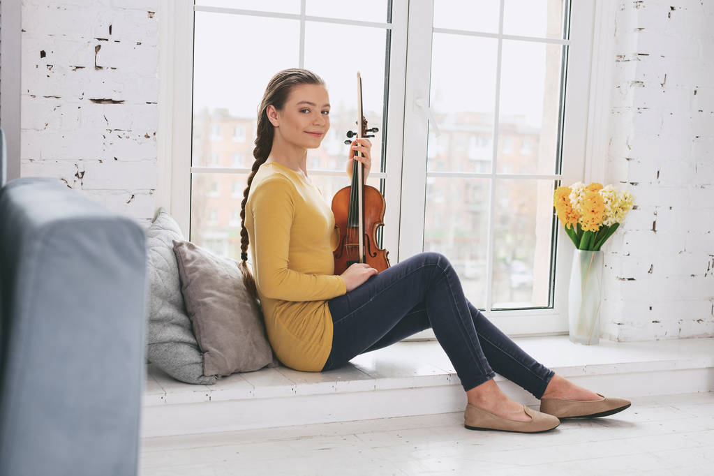 Positive delighted violinist having pause - Photo, Image
