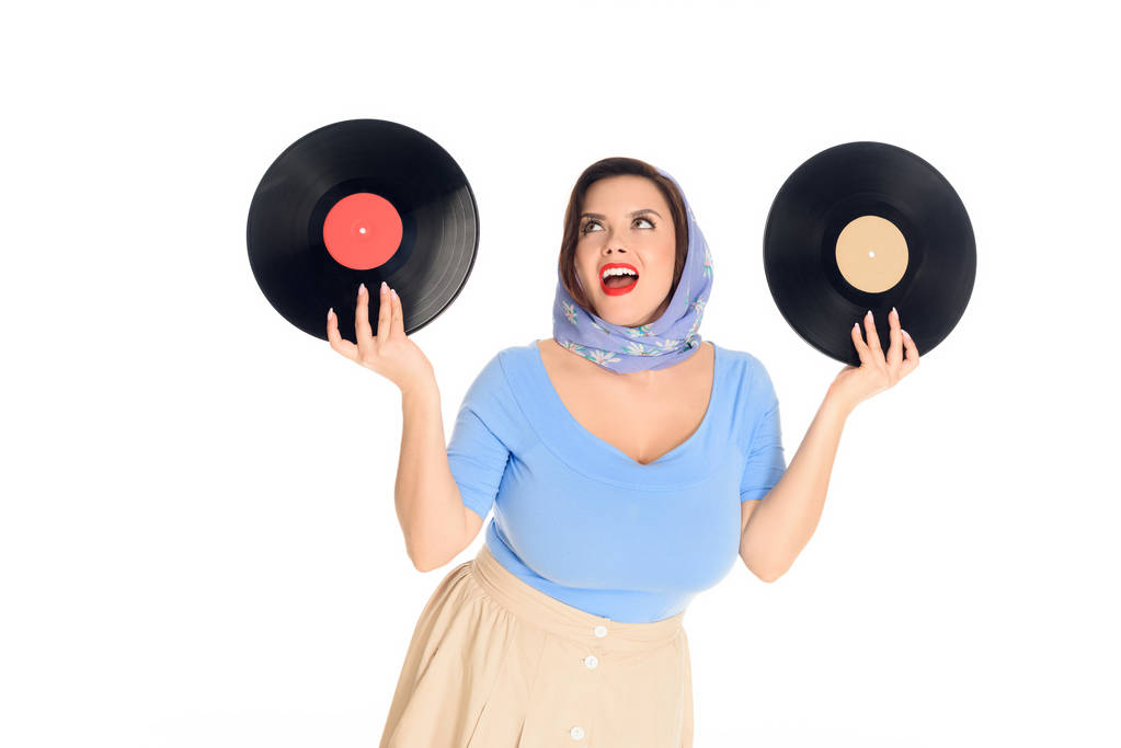 happy stylish pin up woman holding vinyl records isolated on white - Photo, Image