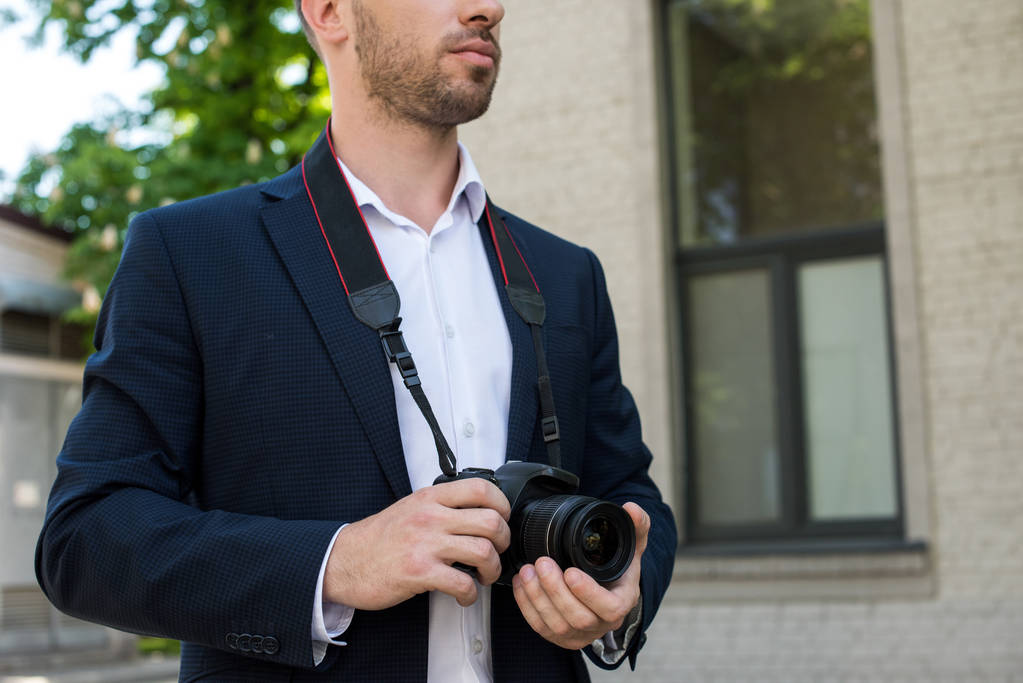 cropped view of photojournalist in formal wear with digital photo camera - Photo, Image