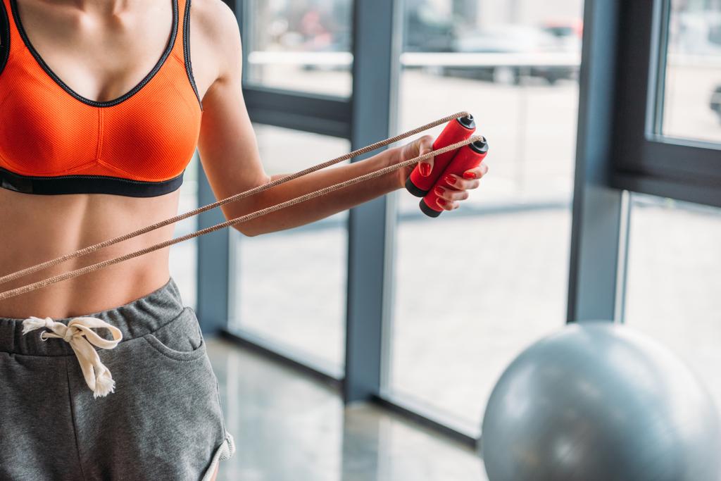 cropped shot of sportswoman holding jump rope at gym - Photo, Image