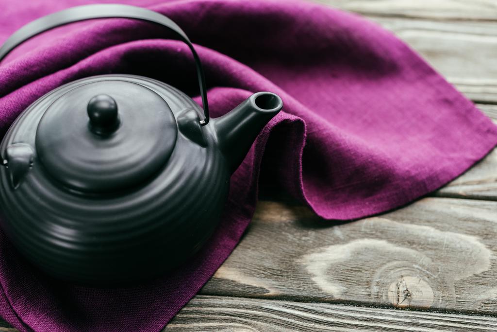 Metal chinese teapot on purple napkin - Photo, Image
