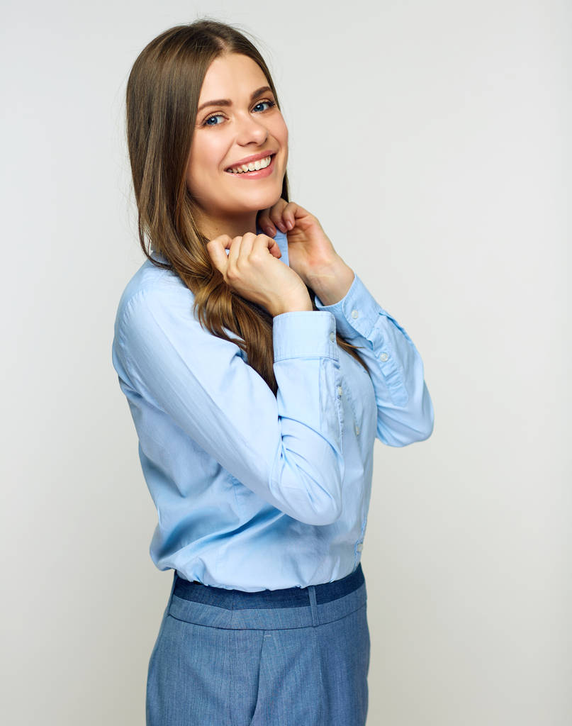 Empresária vestindo camisa azul e saia cinza posando no fundo claro
 - Foto, Imagem