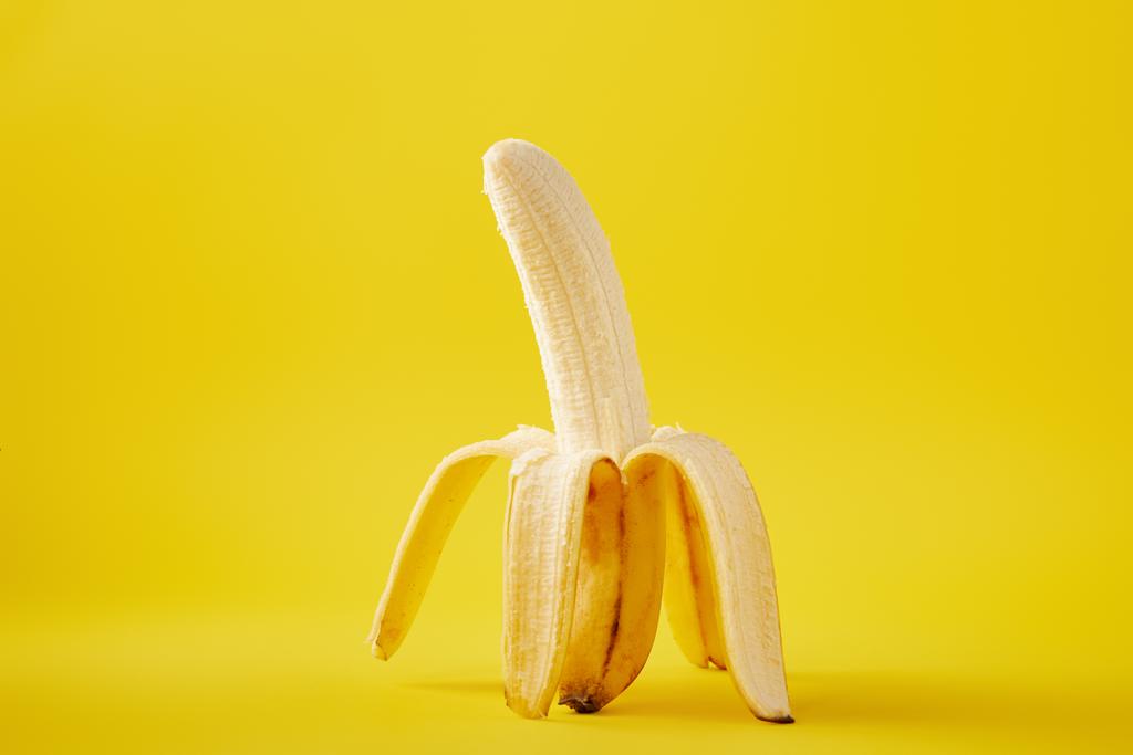 close up view of ripe banana isolated on yellow - Photo, Image