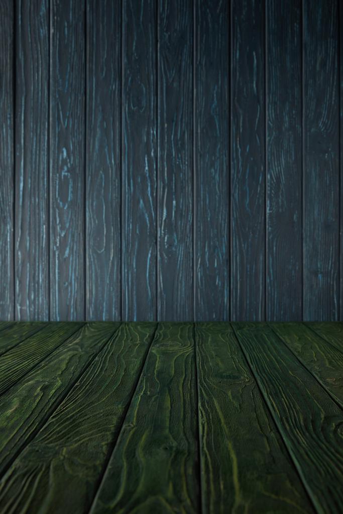 green wooden table and dark blue wooden wall - Photo, Image