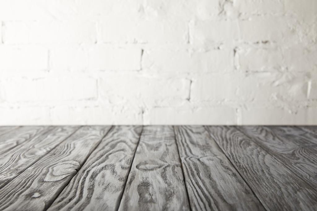 superficie in legno grigio e parete bianca con mattoni
 - Foto, immagini