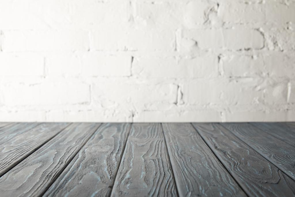 mesa de madera gris y pared blanca con ladrillos
 - Foto, Imagen