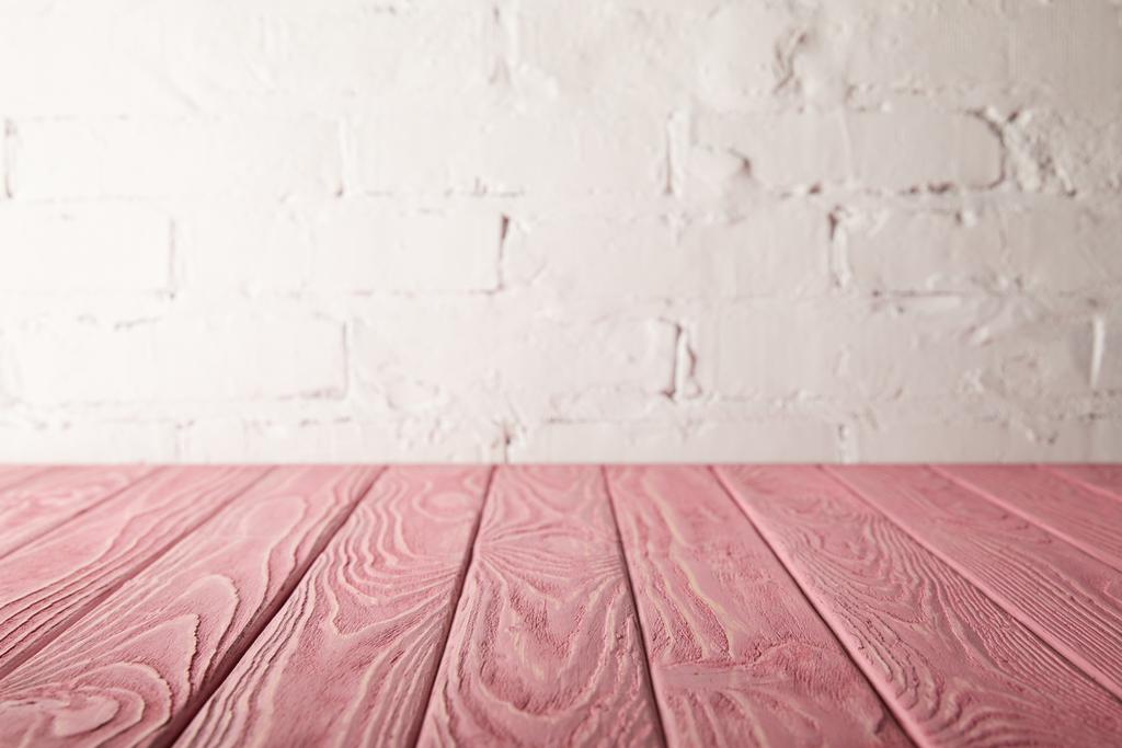 pink wooden tabletop and white wall with bricks - Photo, Image