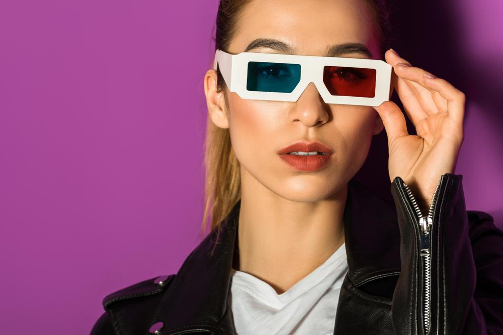 beautiful young asian woman in 3d glasses looking at camera isolated on violet - Photo, Image