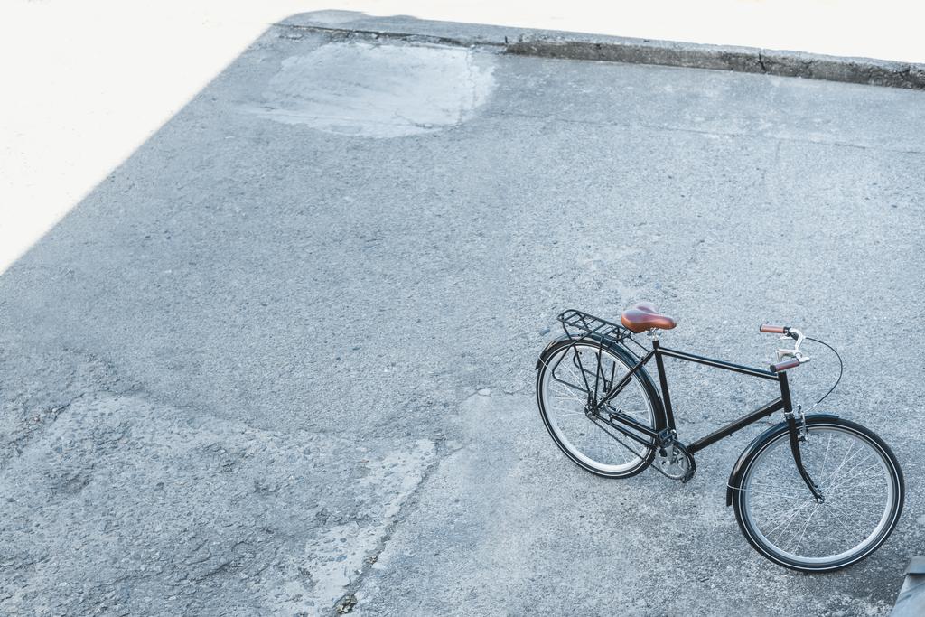 high angle view of one bicycle on street in city - Photo, Image