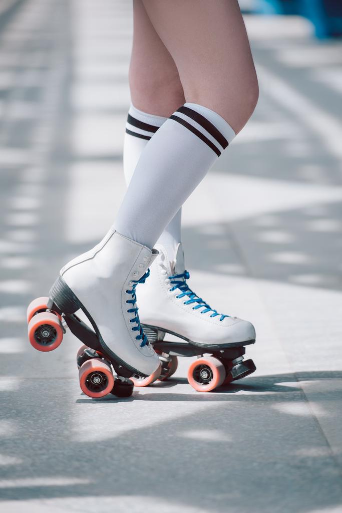 partial view of woman in white high socks with black stripes and retro roller skates - Photo, Image
