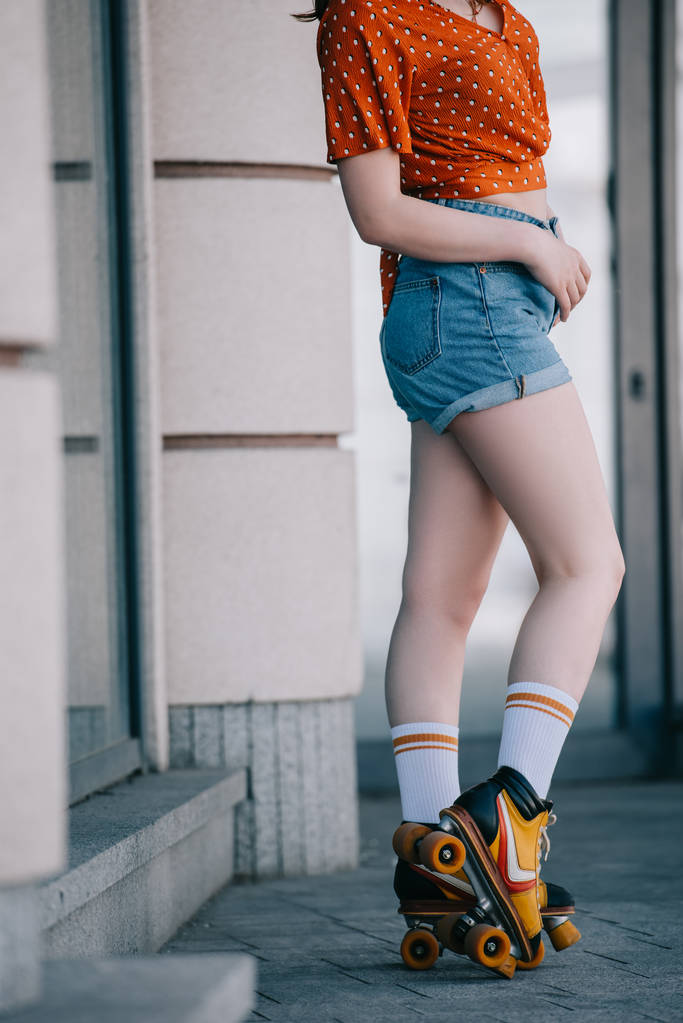cropped shot of stylish young woman in roller skates standing on street - Photo, Image