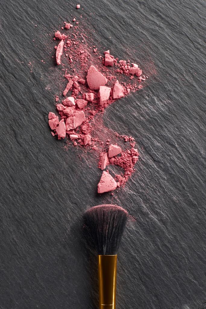 Broken blush and large brush on dark slate background - Photo, Image