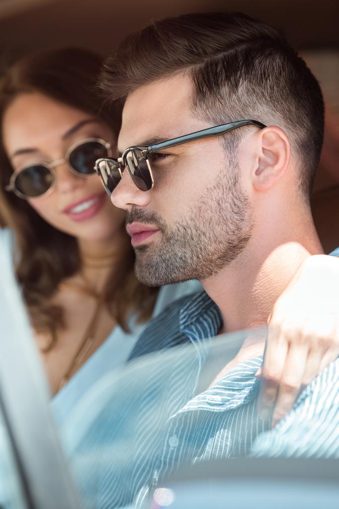 belo jovem casal em óculos de sol carro de condução
 - Foto, Imagem