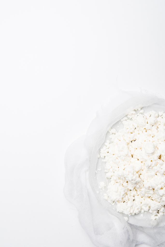 top view of homemade cottage cheese on cheesecloth on white surface - Photo, Image
