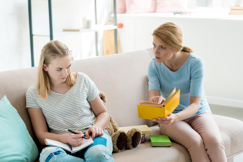 angry mother doing homework together with daughter - Photo, Image