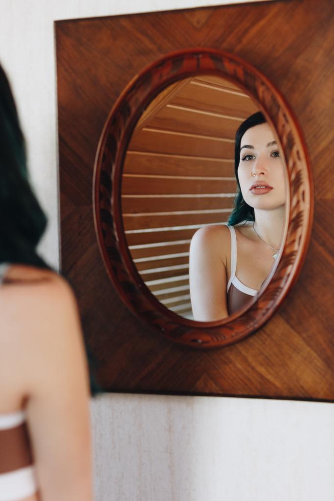 красива молода жінка в нижній білизні дивиться на дзеркало
 - Фото, зображення