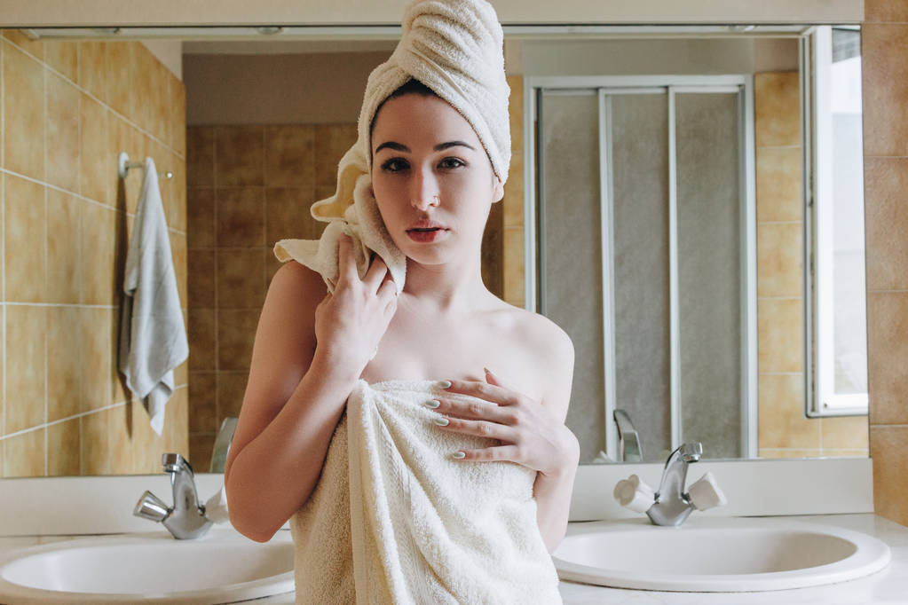 beautiful girl in towels looking at camera in bathroom  - Photo, Image