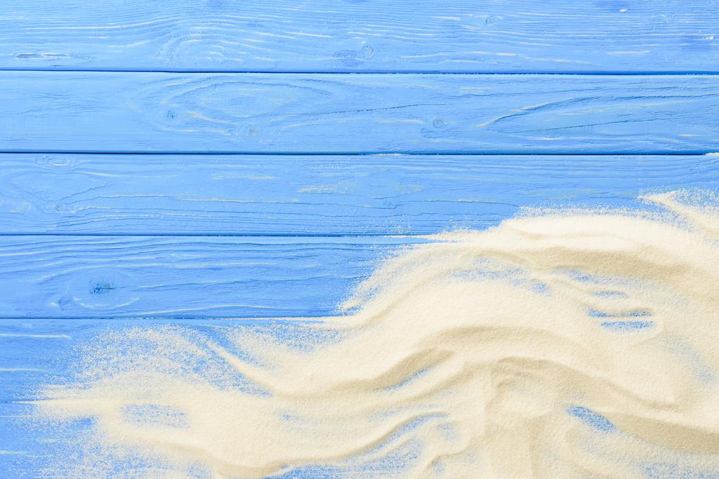 Sand waves on blue wooden background - Photo, Image