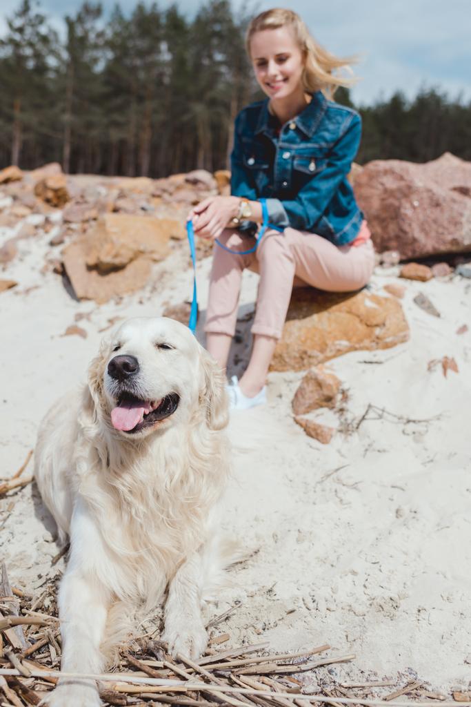 selective focus of woman with golden retriever dog on shore - Photo, Image
