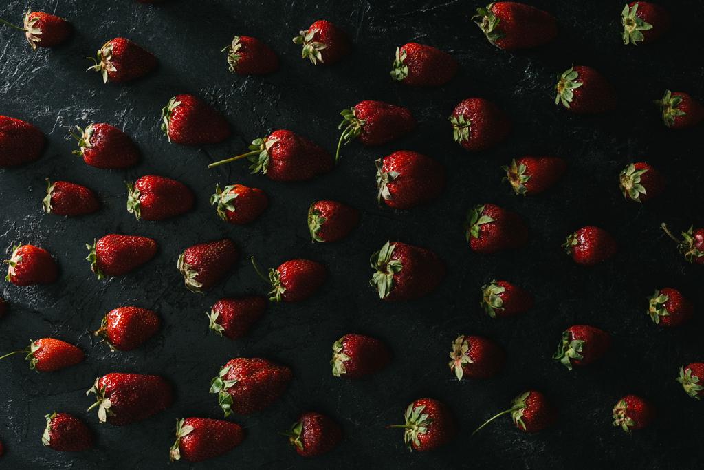 top view of ripe summer strawberries on dark background - Photo, Image