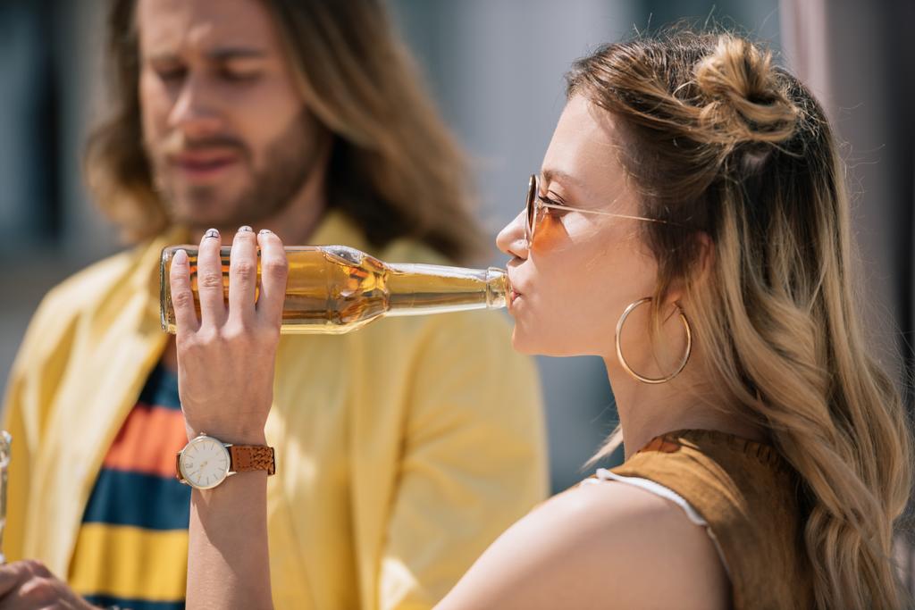 side view of young woman in sunglasses drinking cold beer at sunny day - Photo, Image