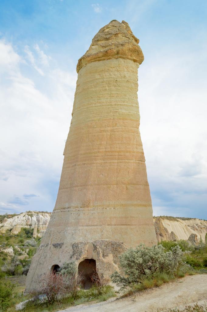 close up view of fairy chimney in valley under cloudy blue sky, Cappadocia, Turkey - Photo, Image