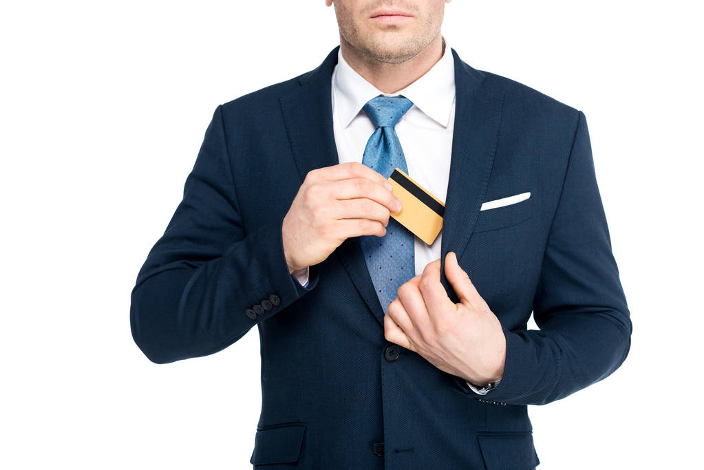 cropped shot of businessman putting credit card in suit jacket pocket isolated on white - Photo, Image