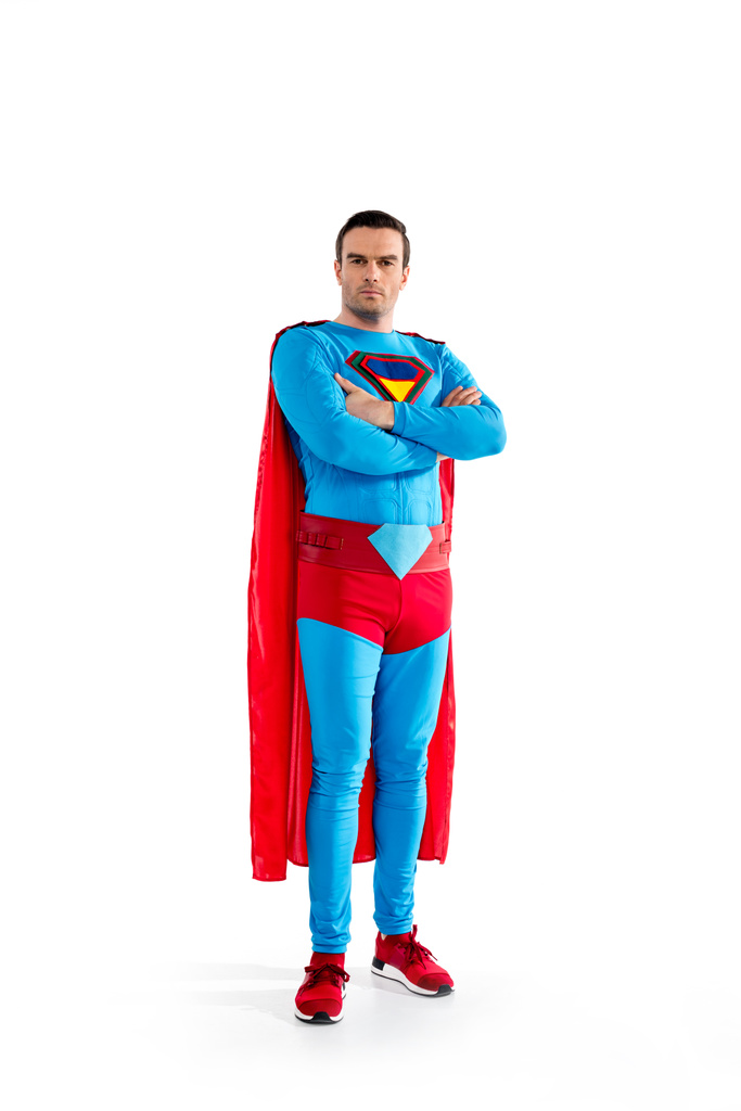 full length view of confident handsome superman standing with crossed arms and looking at camera isolated on white  - Photo, Image