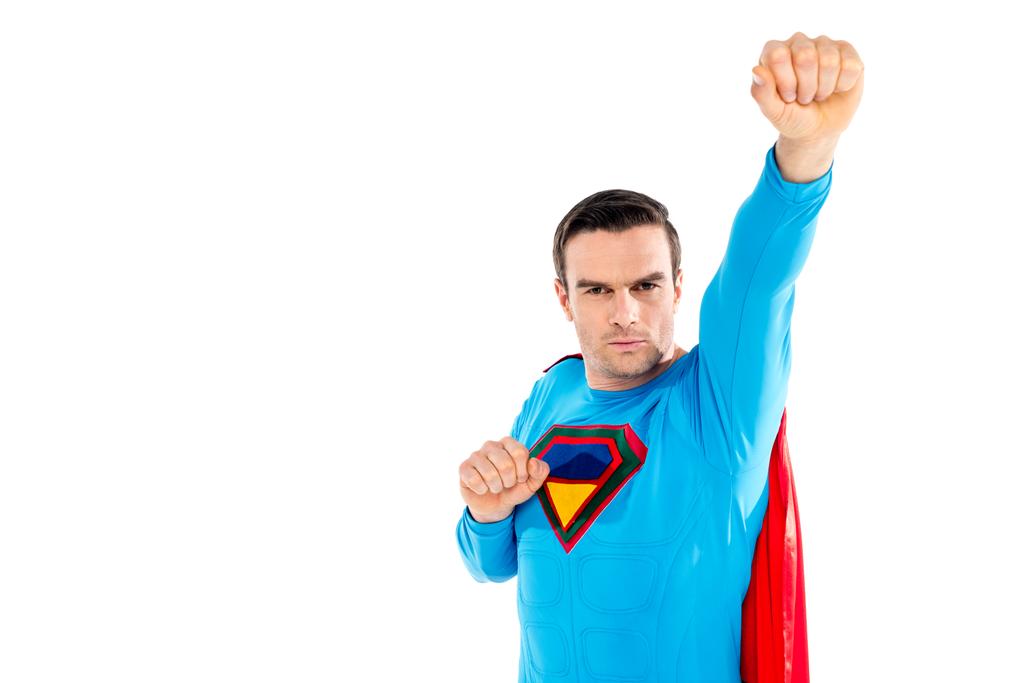 красивий чоловічий супергерой піднімає руку і дивиться на камеру ізольовано на білому
 - Фото, зображення